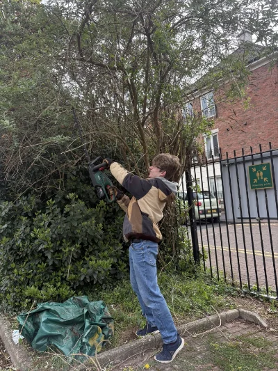 Image depicting a member of staff trimming hedges at Sensory Matters' premises